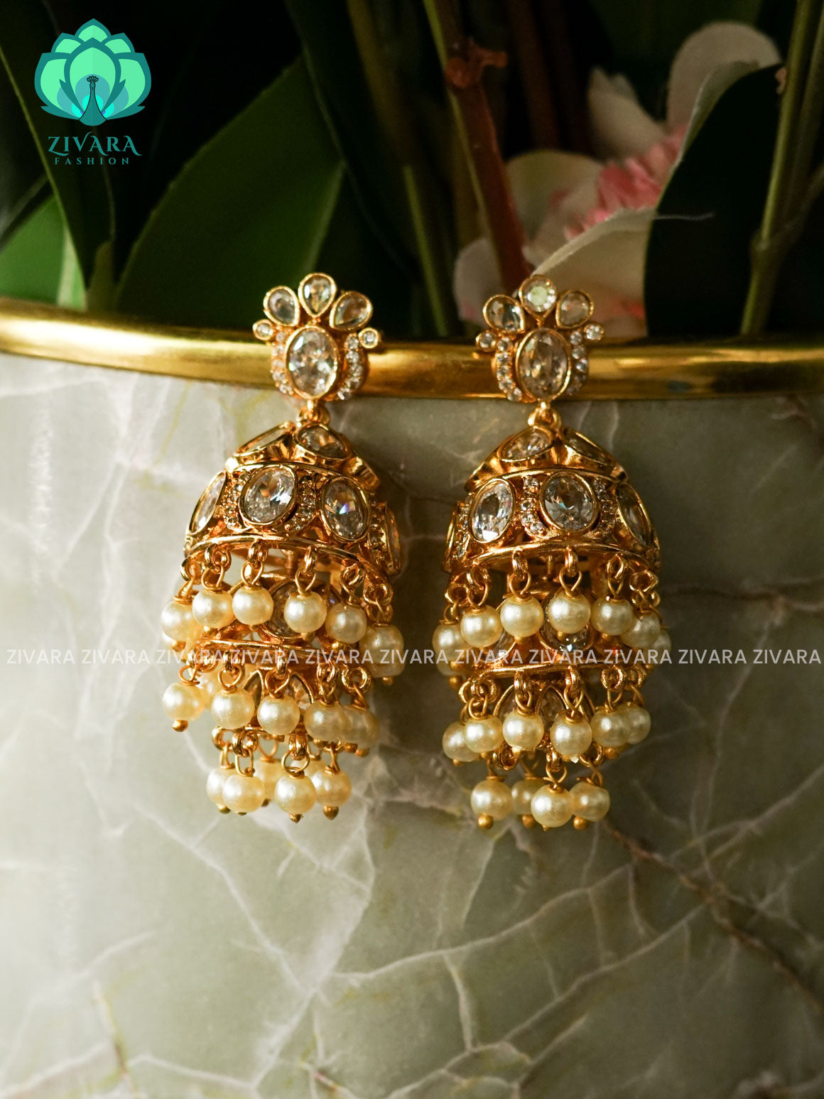 DIYA - WHITE FLOWER THREE LAYER  WHITE STONE JHUMKA - TRADITIONAL PREMIUM MATTE  polish JHUMKA- latest jewellery collection- zivara fashion