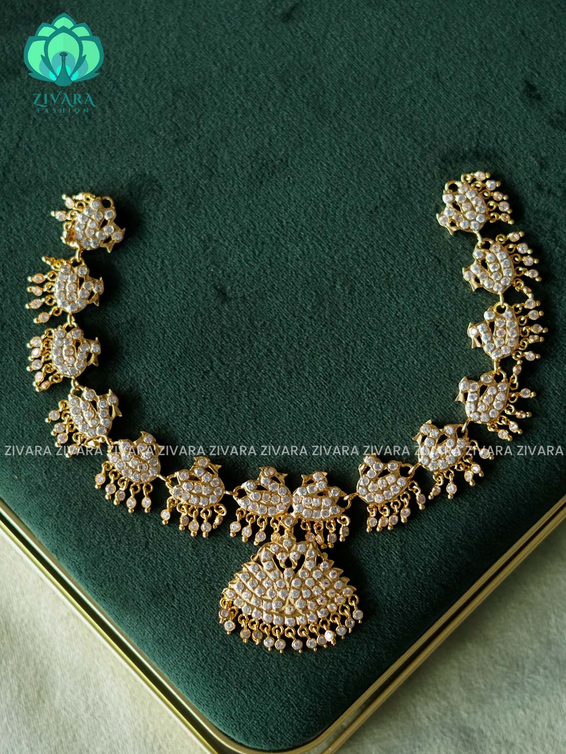 AMBIGAI-WHITE STONE PEACOCK MOTIF MICROGOLD POLISH ATTIGAI WITH EARRING - Zivara Fashion- latest jewellery desigN