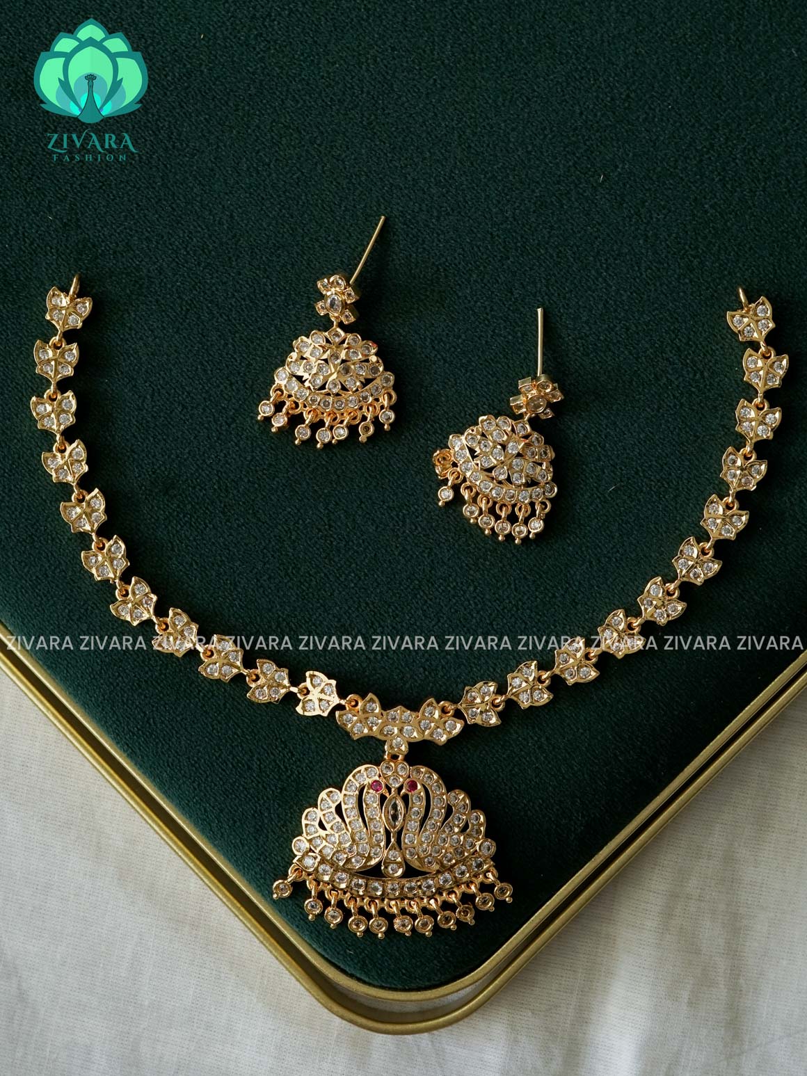 AMBIGAI- WHITE AND RUBY STONE PEACOCK MOTIF MICROGOLD POLISH ATTIGAI - Zivara Fashion- latest jewellery design